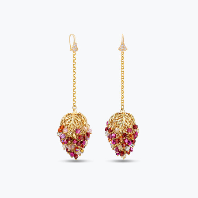 Long gold drop earrings featuring a handknitted wire mesh pod tightly packed with red and pink premium crystals.