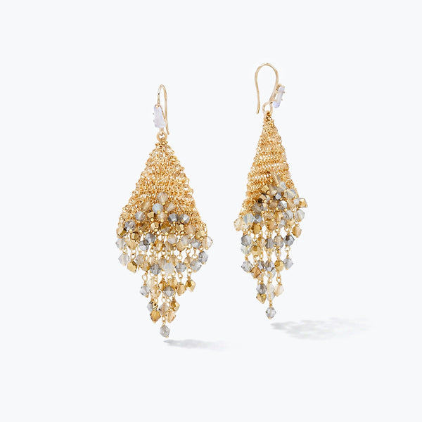 Gold drop earrings showing a vertical handknitted trianglular wire mesh holding individually hanging clear and champagne crystals.