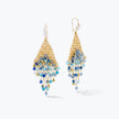 Gold drop earrings featuring a handknitted wire triangle shape accented by cascading blue and silver premium crystals.