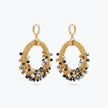 Gold loop earrings featuring a crescent handknitted wire outline and individually hanging black and bronze crystals.