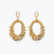 Gold loop earrings with a crescent handknitted wire loop structure holding clear and champagne reflective crystals.
