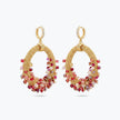Gold loop earrings showcasing a curved crescent handknitted wire base with cascading red and pink premium crystals.
