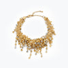 Gold bracelet featuring an openwork handknitted wire embedded with clear and champagne premium hanging crystals.