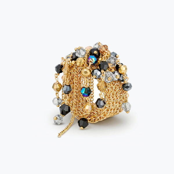Gold handknitted wire statement ring featuring reflective crystals in bronze, hematite black, and silver.