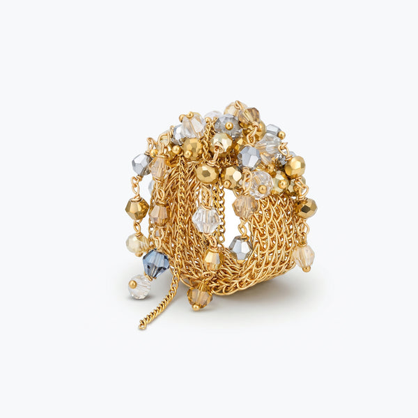 Gold handknitted wire statement ring showcasing reflective crystals in champagne, clear, and gold tones.