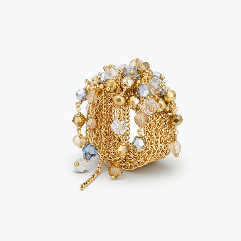 Gold handknitted wire statement ring showcasing reflective crystals in champagne, clear, and gold tones.