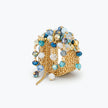Gold handknitted wire statement ring featuring embedded blue, turquoise, and white premium crystals.