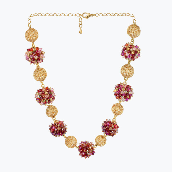 Gold handknitted sphere wire mesh ball necklace featuring individually hanging red, hot pink, and white crystals.