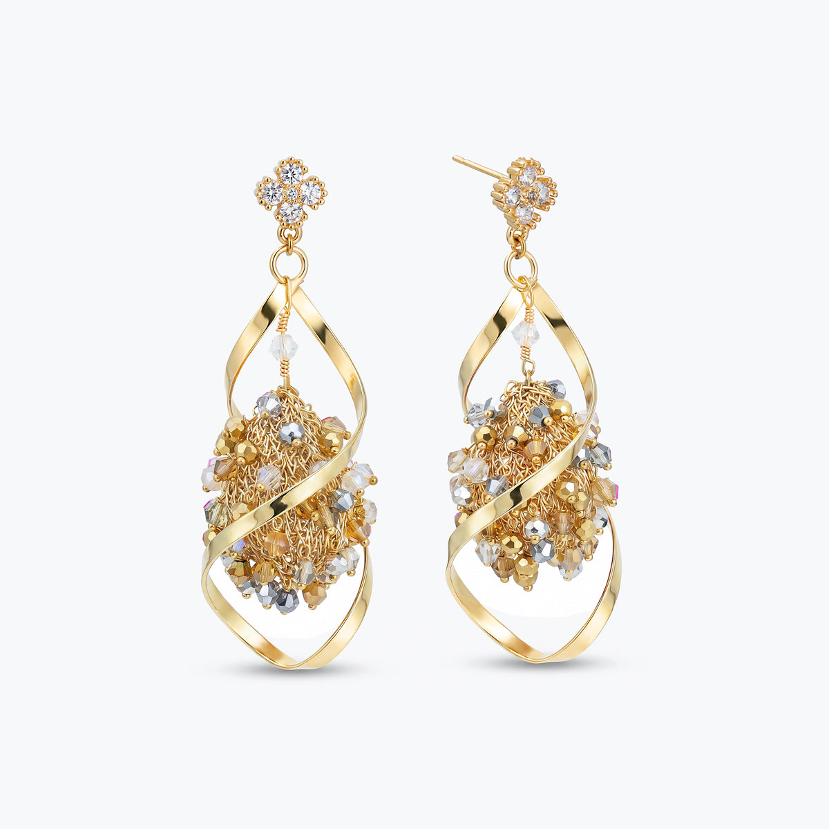 Gold drop earrings showcasing an octagonal handknitted wire structure with individually hanging green premium crystals.
