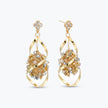 Gold drop earrings showcasing an octagonal handknitted wire structure with individually hanging green premium crystals.
