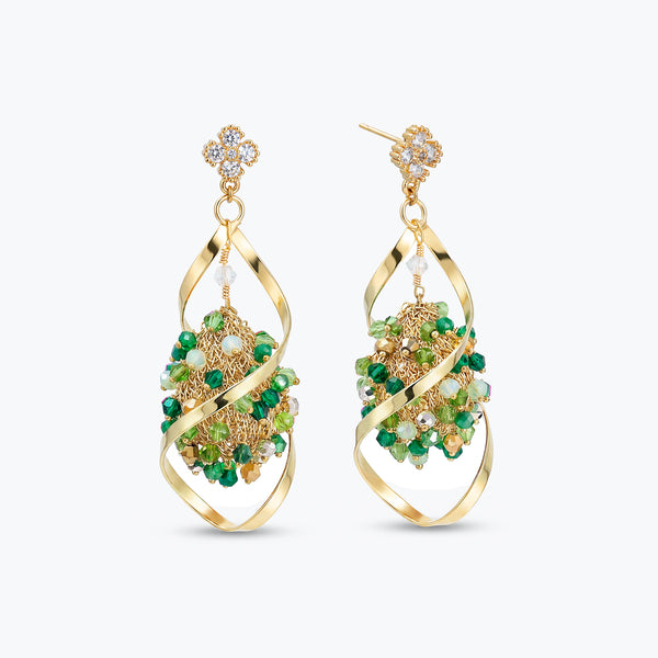 Gold drop earrings showcasing an octagonal handknitted wire structure with individually hanging green premium crystals.
