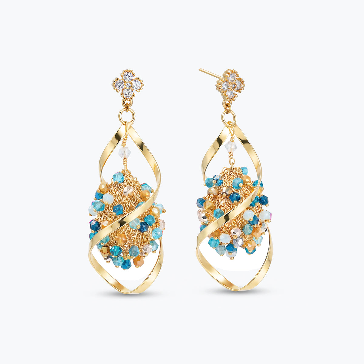 Gold drop earrings featuring an octagonal handknitted wire mesh panel holding blue and gray reflective crystals.
