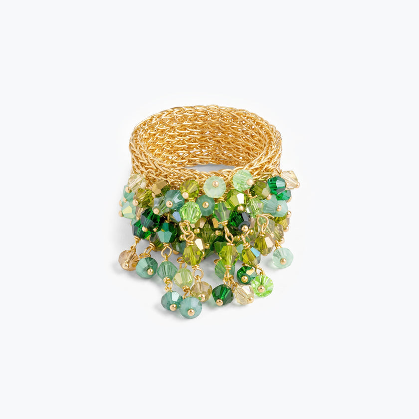 Wide gold ring crafted from hanknitted wire mesh with a fringe of green premium crystals.