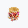 Wide gold mesh band ring featuring individually hanging crystals in magenta, red, and pink hues.