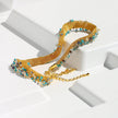 Gold necklace with gemstones on a white background