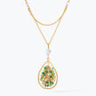 Gold handknitted tear drop wire mesh pendant necklace displaying a crescent cluster of green premium crystals.