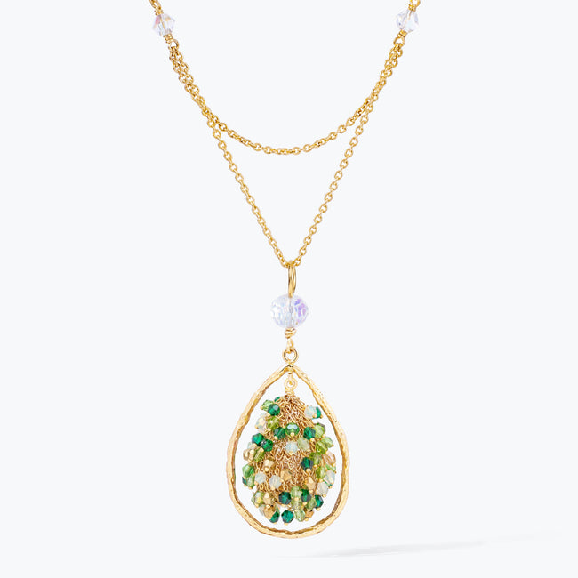 Gold handknitted tear drop wire mesh pendant necklace displaying a crescent cluster of green premium crystals.