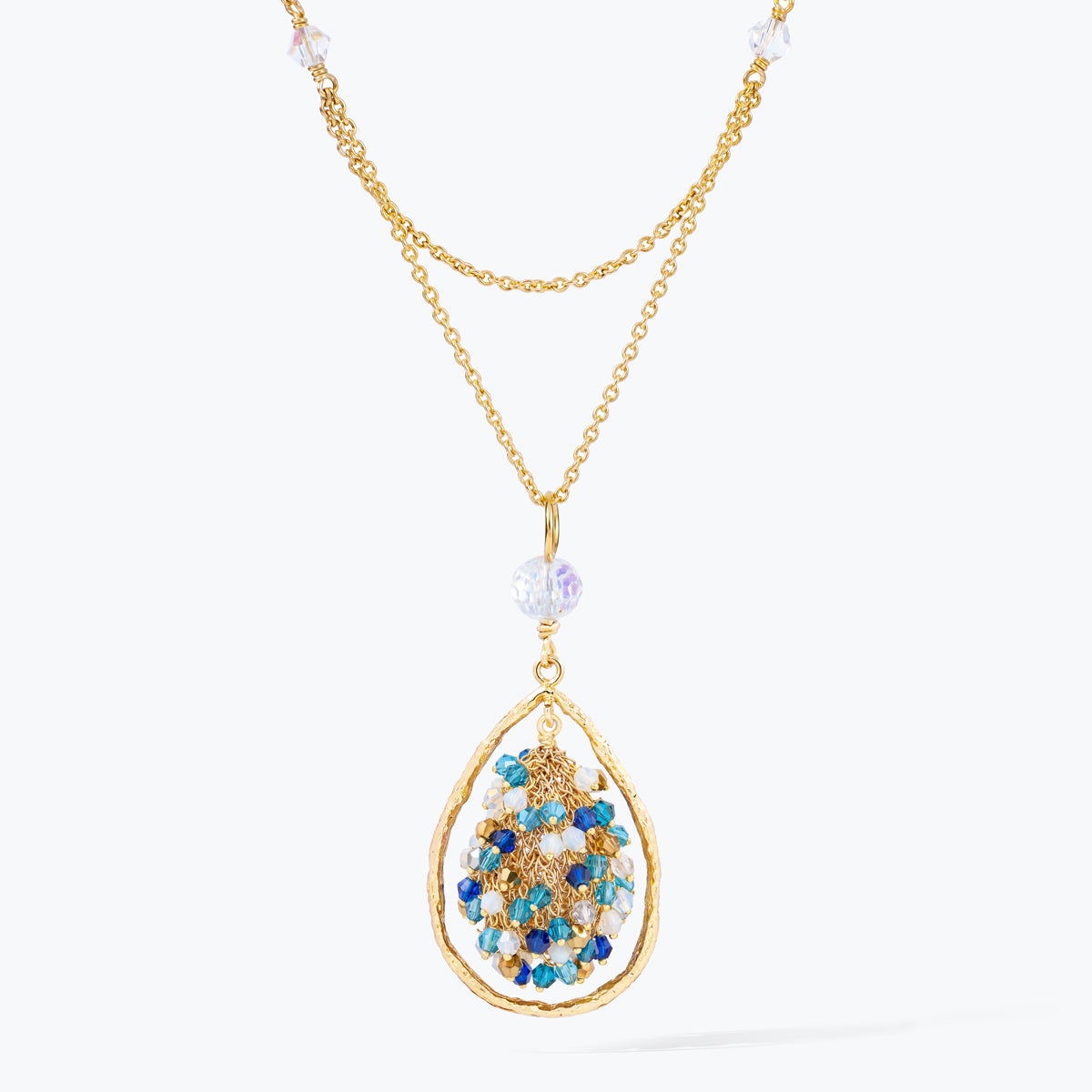Gold handknitted tear drop wire mesh pendant necklace featuring a crescent bib design with blue and aqua premium crystals.