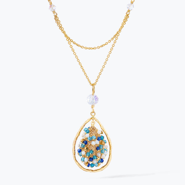 Gold handknitted tear drop wire mesh pendant necklace featuring a crescent bib design with blue and aqua premium crystals.