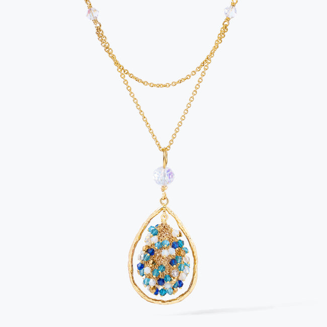Gold handknitted tear drop wire mesh pendant necklace featuring a crescent bib design with blue and aqua premium crystals.