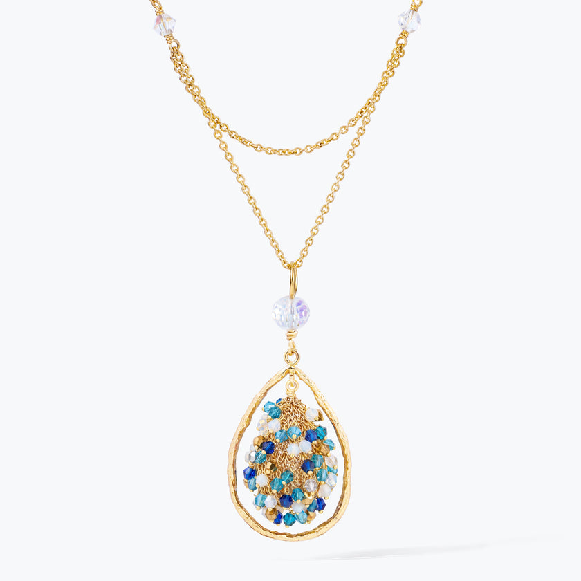 Gold handknitted tear drop wire mesh pendant necklace featuring a crescent bib design with blue and aqua premium crystals.