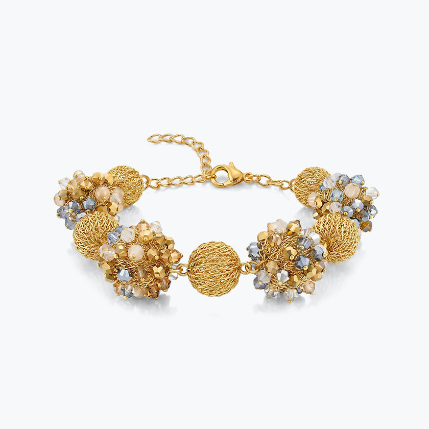 Gold bracelet featuring 9 ball handknitted wire mesh set with clear and champagne crystals.