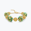 Gold bracelet featuring 9 ball handknitted wire holding emerald and mint green premium crystals.