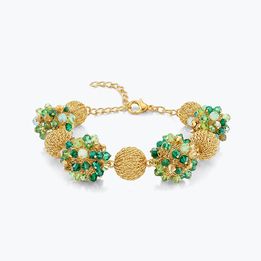 Gold bracelet featuring 9 ball handknitted wire holding emerald and mint green premium crystals.