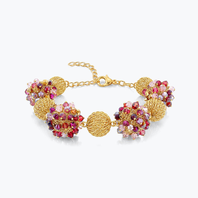Gold bracelet featuring 9 ball handknitted wire design with individual pinned fuchsia and red crystals.