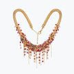 Gold handknitted wire collar necklace featuring individually hanging pink, red, and fuchsia premium crystals.
