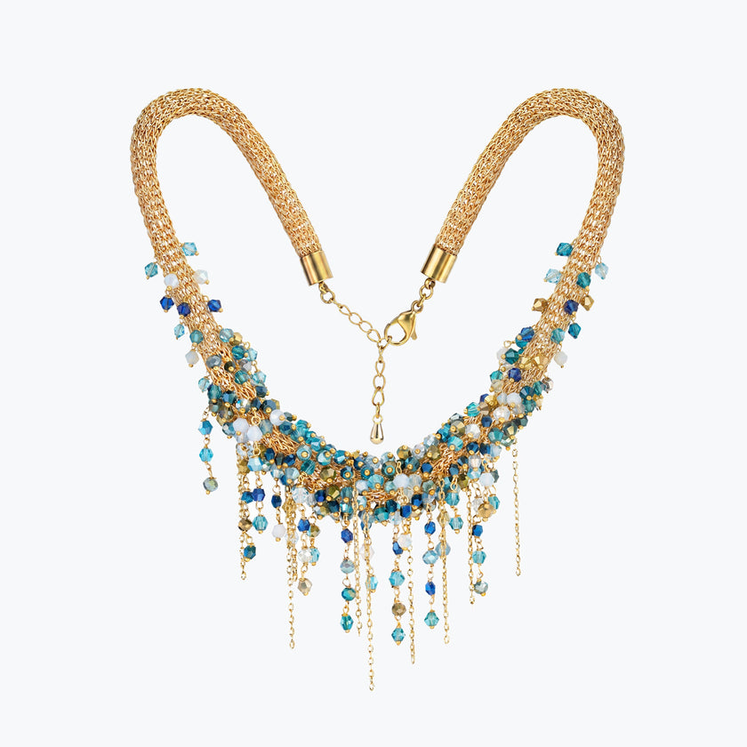 Gold handknitted wire mesh collar necklace with individually hanging blue, teal, and clear premium crystals.