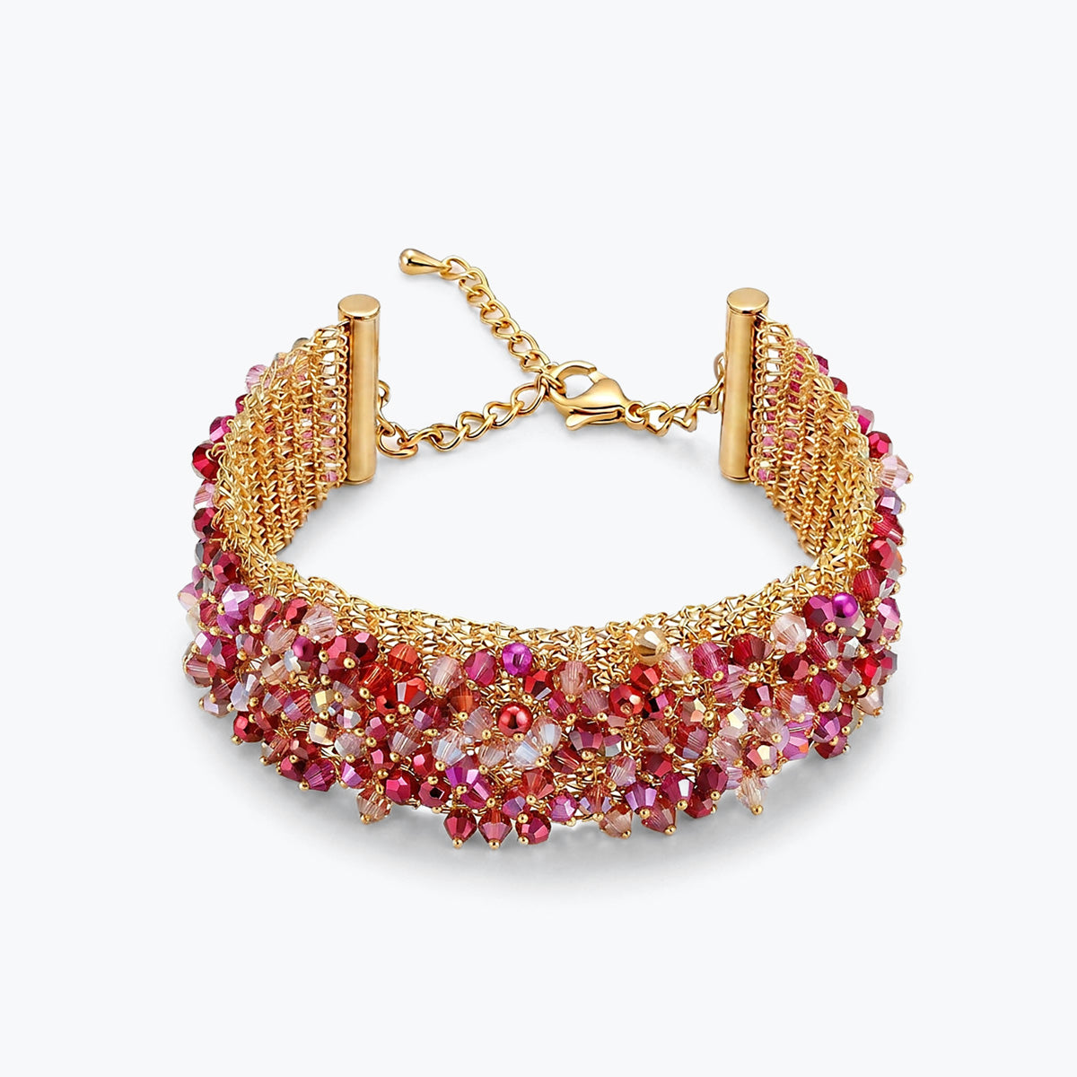 Gold ribbon bracelet showing a handknitted wire mesh layout adorned with vibrant red and pink crystals.