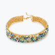 Gold handknitted wire choker necklace featuring premium crystals in vibrant blue, turquoise, and white.