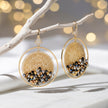 Gold handknitted wire mesh hoop earrings with reflective crystals in bronze, black, and metallic silver.